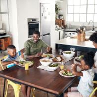 Shot of young family eating a meal together at home