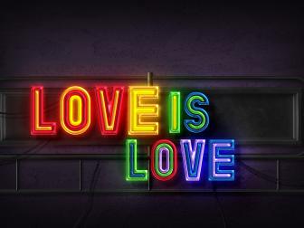 love is love text in rainbow neon style on wall
