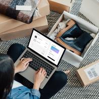 High angle view of young woman making credit card payment while doing online shopping on laptop. Technology makes shopping easier. Mockup image for woman doing online shopping.