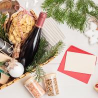 Refined Christmas gift basket for culinary enthusiats with bottle of wine and italian cusine ingredients. Corporate or personal present for cooking lovers, foodies and gourmands.