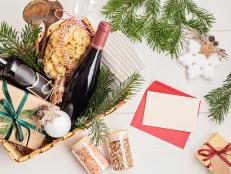 Refined Christmas gift basket for culinary enthusiats with bottle of wine and italian cusine ingredients. Corporate or personal present for cooking lovers, foodies and gourmands.