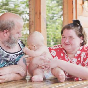 Parents Amy & Michael play with baby Gage at the family’s vacation cabin.