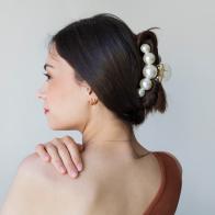 Young woman with beautiful hair clips on grey background