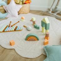 Beautiful decoration nursery with wicker baskets, linen rug, cushions and wooden toys. Perfect spot for playtime. Plastic free. Zero waste and ecological concept.