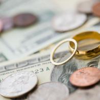 Close up of wedding rings with money