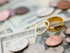 Close up of wedding rings with money