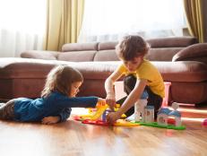 Cute two little children playing with toys at home