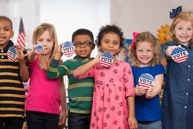 Students with vote buttons in kindergarten class