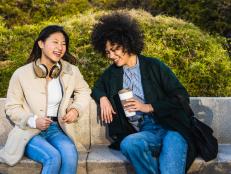 Beautiful asian women joking and spending a relaxing afternoon in the park. Enjoying the nice spring weather outside after work.