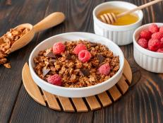 Bowl of homemade granola with fresh raspberries