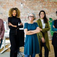 Portrait of successful female business team in office. Multiracial business group standing together and looking at camera.