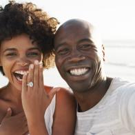 Cropped portrait of an affectionate young couple taking selfies on the beach after their engagement