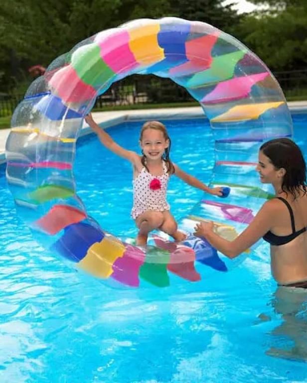 Colorful bottles floating in childs inflatable swimming pool