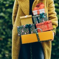 Woman holding stack of Christmas gift. New Year or Christmas concept.