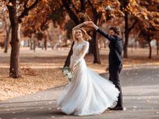 Beautiful wedding couple in park dancing