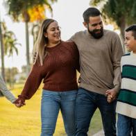 Family talking while walking through the public park