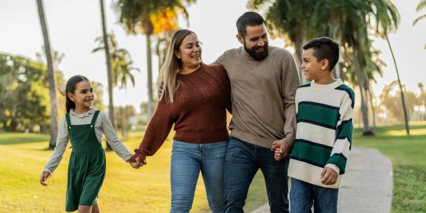 Family talking while walking through the public park