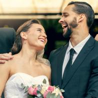 Wedding, happy and couple with parents at a celebration of love at an event with happiness. Smile, celebrate and young bride and groom after marriage with mother and father together at a church