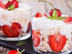 Eton Mess - Strawberries with whipped cream and meringue in a glass beaker. Classic British summer dessert.selective focus