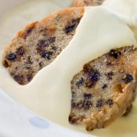 Bowl of Spotted Dick with Custard on Table