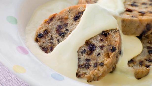 Bowl of Spotted Dick with Custard on Table