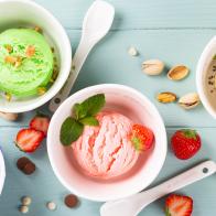 Homemade assorted ice cream on light blue wooden background. Healthy summer food concept. Top view, copy space.