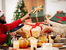 The family is happily exchanging gifts at Christmas.