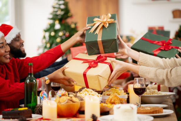 The family is happily exchanging gifts at Christmas.