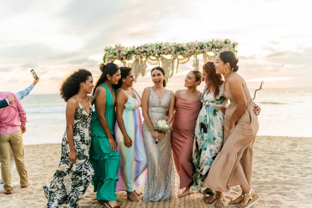 Bride talking with her friends in the wedding party on the beach