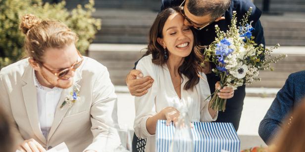 The bride and groom are dining at a table after the wedding