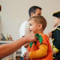 Photo of costumed family, playing make believe at home