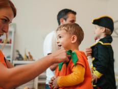 Photo of costumed family, playing make believe at home