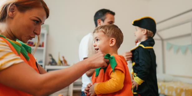 Photo of costumed family, playing make believe at home