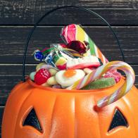 Happy halloween! Pumpkin with candy in the home.