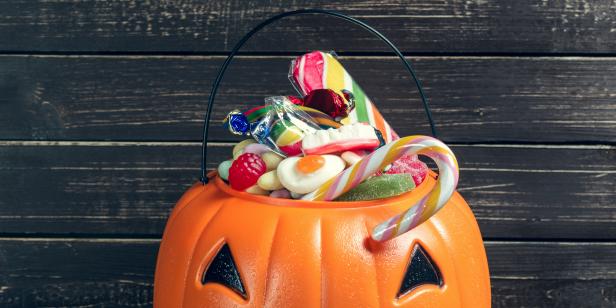 Happy halloween! Pumpkin with candy in the home.