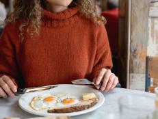 Portrait of a happy woman having breakfast at a cafe in London - food and drinks concepts 