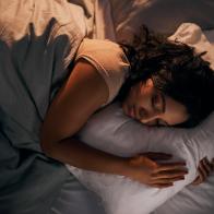 High angle shot of a beautiful young woman sleeping in her bed at home during the night