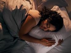 High angle shot of a beautiful young woman sleeping in her bed at home during the night