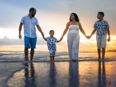 Hispanic family walking on empty beach Florida
