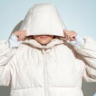 Portrait of teenage girl wearing white hooded jacket and face covered.Studio shot 