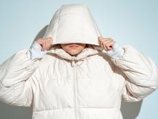 Portrait of teenage girl wearing white hooded jacket and face covered.Studio shot 