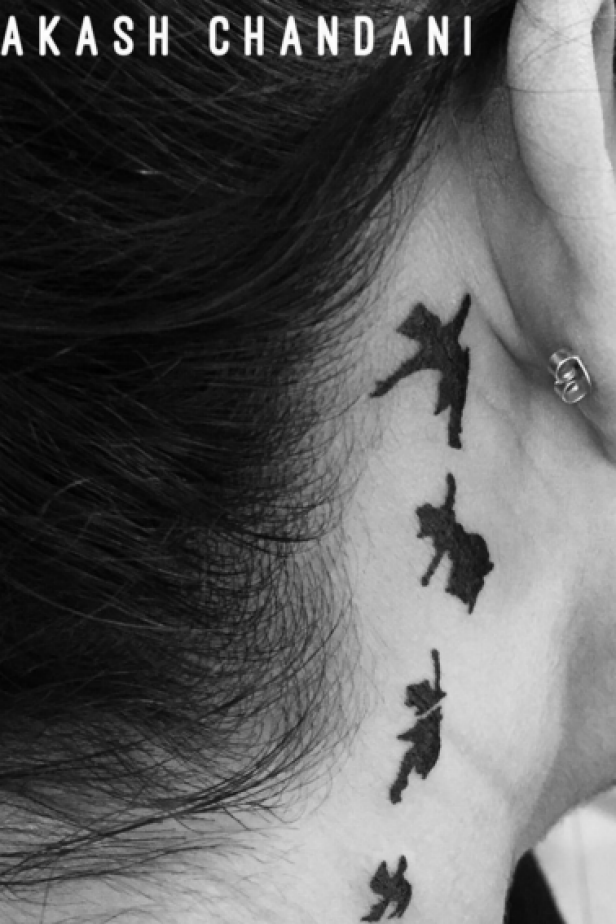 bird tattoo behind ear meaning