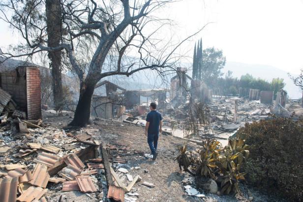 WEST HILLS, CA - NOVEMBER 10: Greg Meneshian walks between the rubble of his burned down home at 46 Dapplegray Rd. And that of his neighbor's destroyed home on Saturday, November 10, 2018. The Woolsey fire swept through Meneshian's Bell Canyon neighborhood of West Hills on Friday. (Photo by Kevin Sullivan/Digital First Media/Orange County Register via Getty Images)