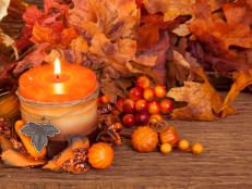 Autumn candle over wooden background